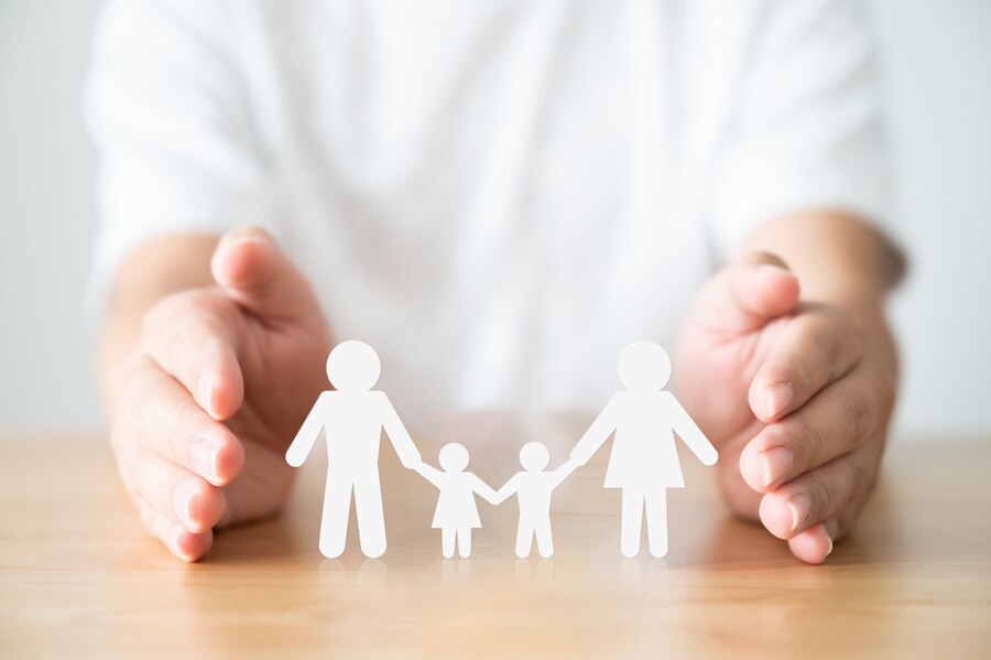 hand-protecting-family-wood-table-healthcare-life-insurance-concept_20693-528